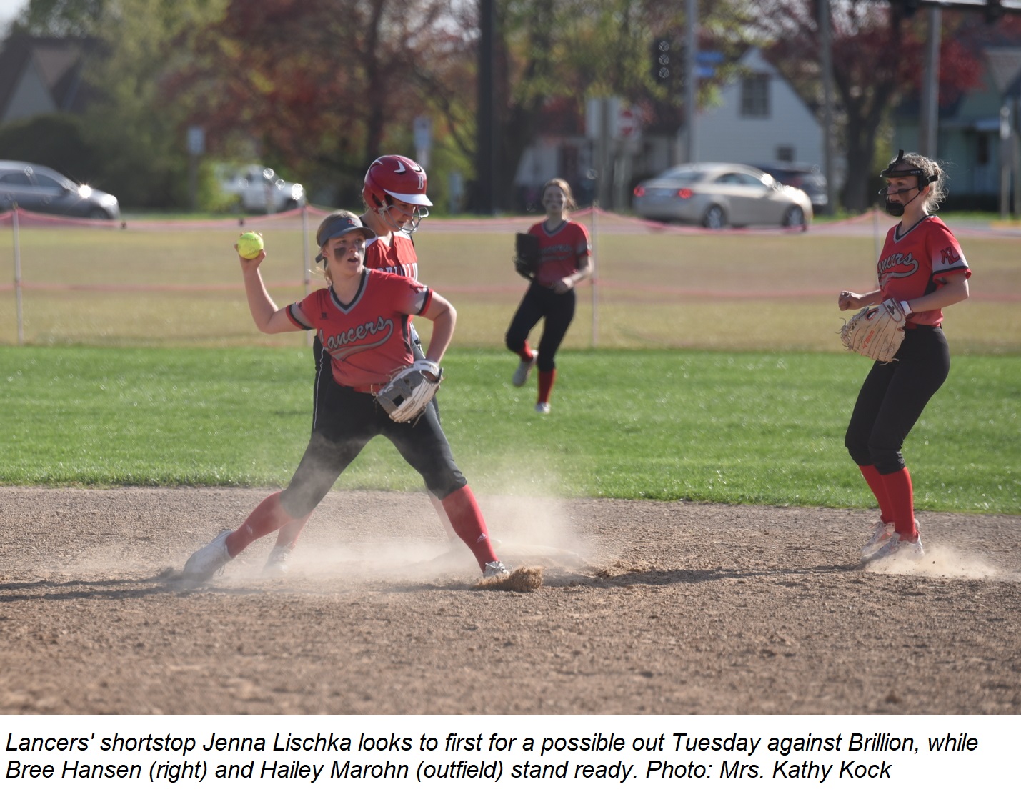 Shortstop Jenna Lischka looks to first for a potential out during the game against Brillion Tuesday. Bree Hansen and Hailey Marohn stand ready.