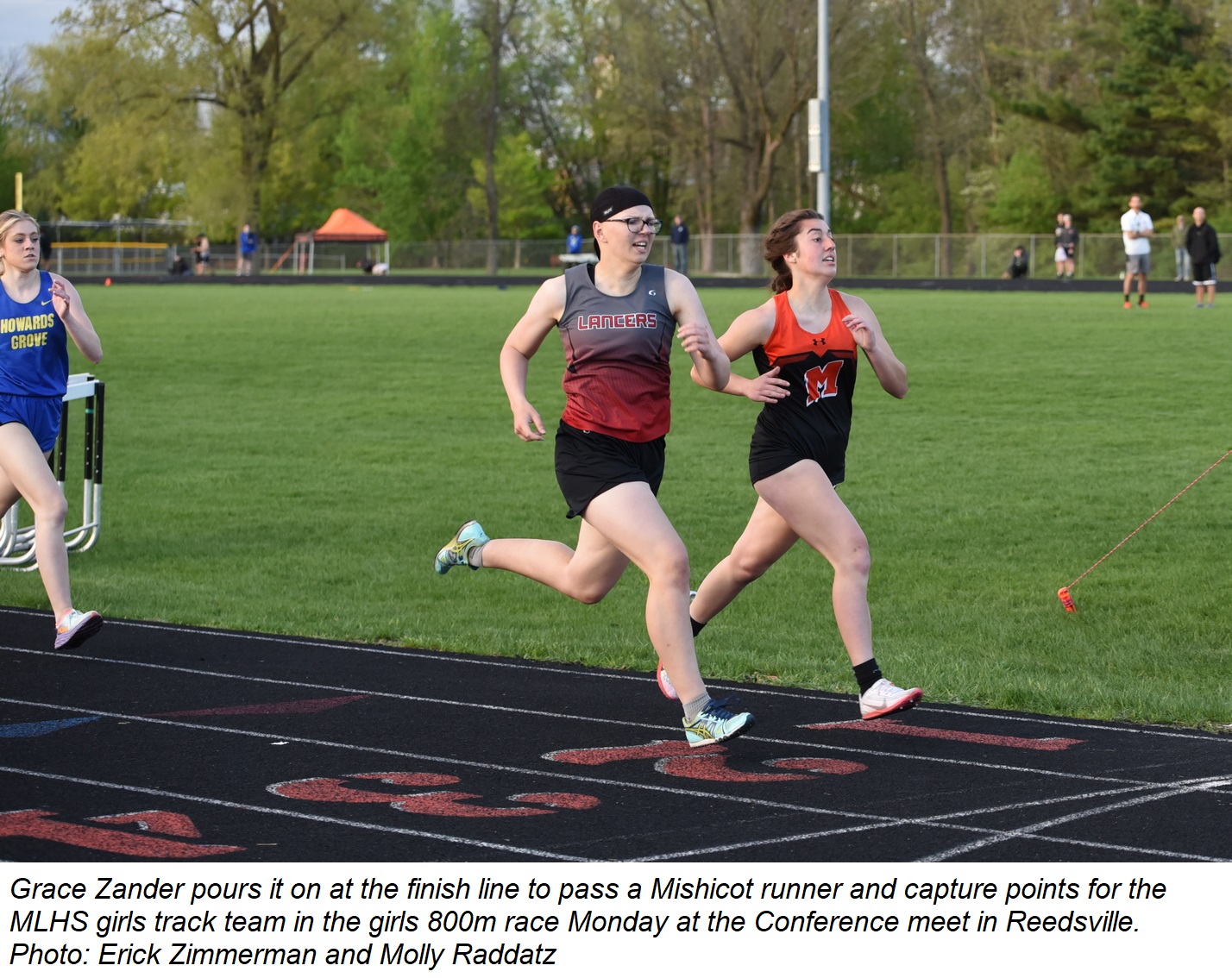 Grace Zander pours it on at the finish line to pass a Mishicot runner during the girls 800m race at the Conference Meet in Reedsville.